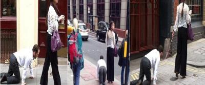 امرأة مستبدة تسحب رجلا بسلسلة من عنقه وتتجول به في شوارع جاثيا على ركبتيه !!